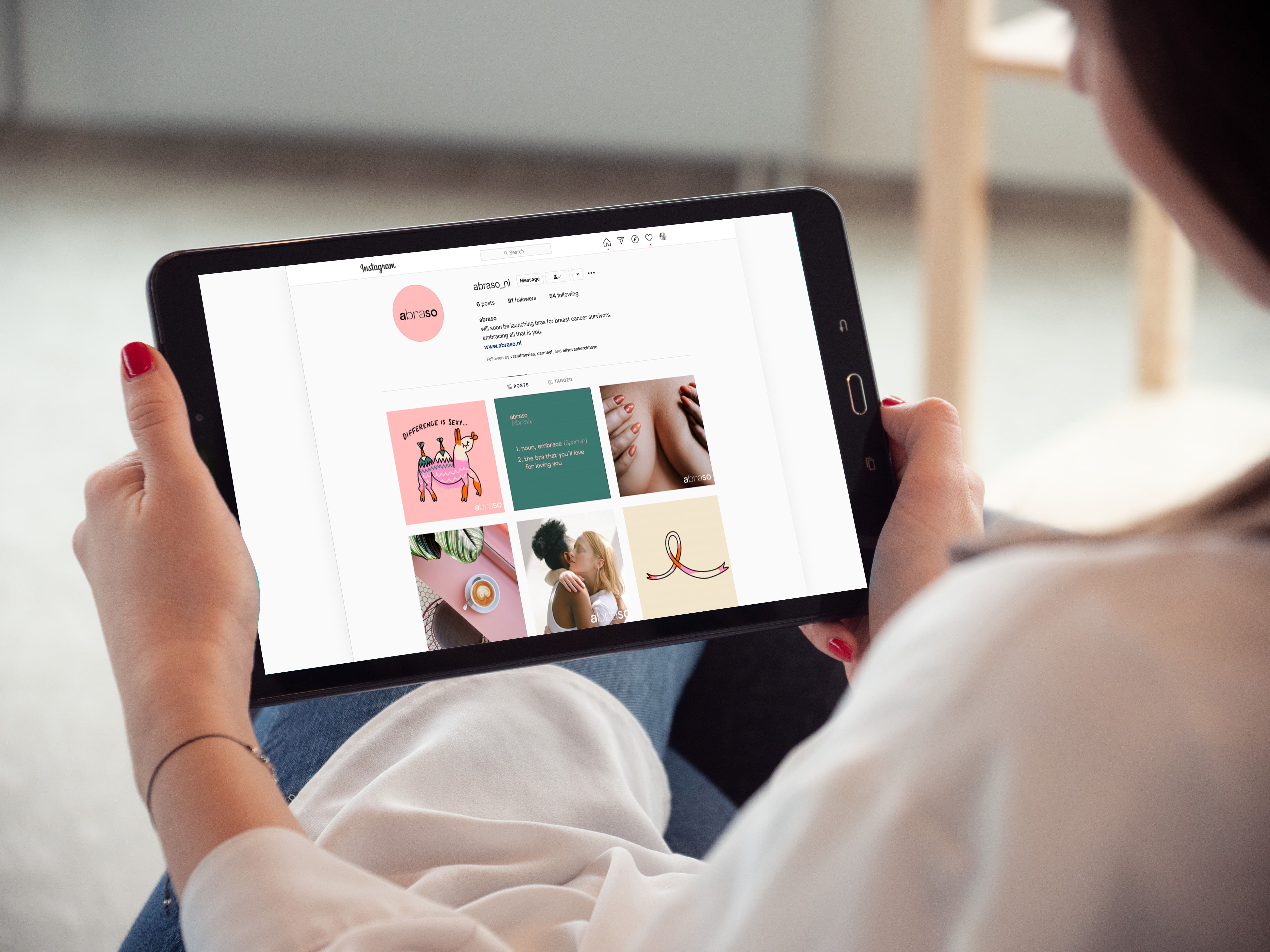 Person viewing Abraso’s social media branding created by The Aha Moment studio.